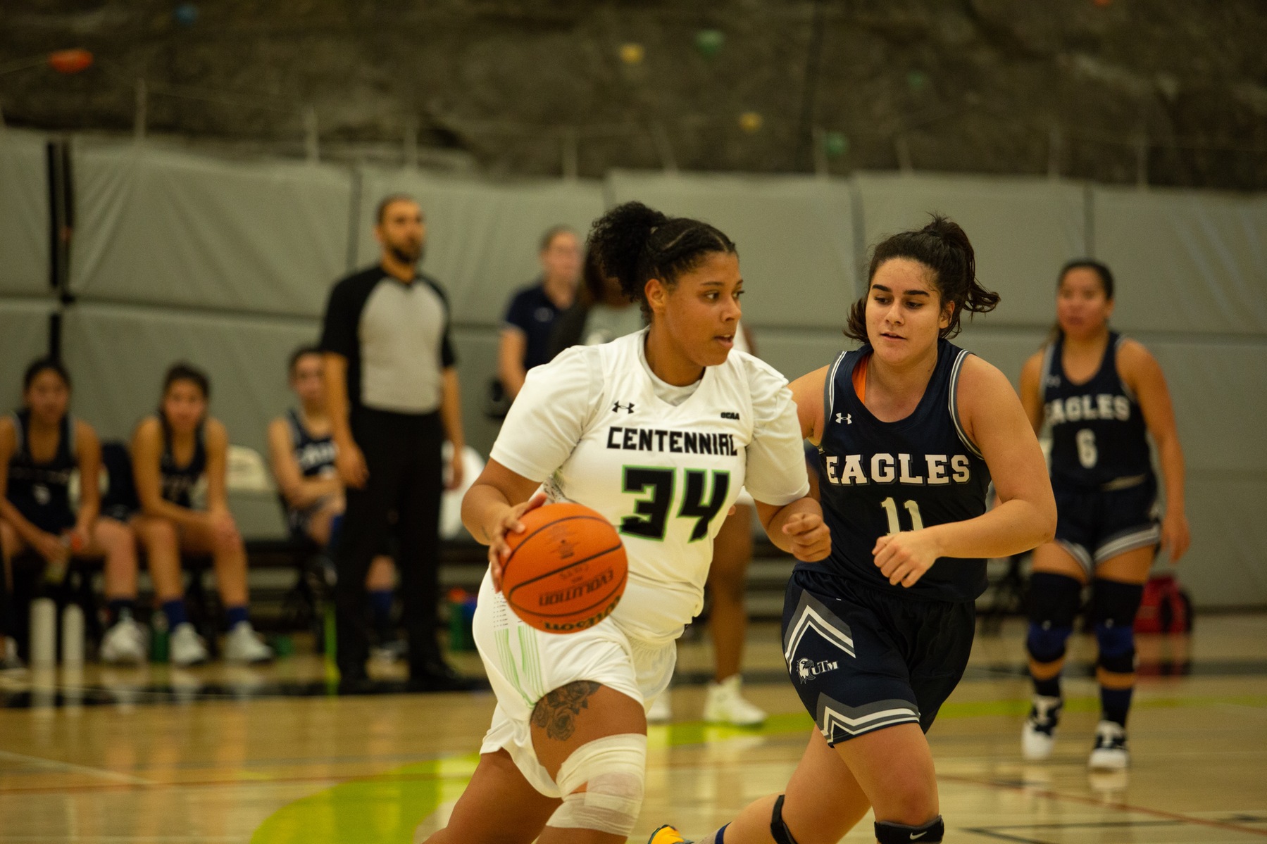 Centennial's Olivia Thomson drives past UTM's Pinar Armagan-Kahram during exhibition action at the Athletic and Wellness Centre between the Colts and the Eagles. (Nicole Ventura/Colts Media)